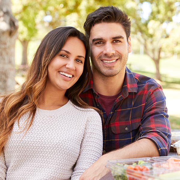 couple smiling in the park